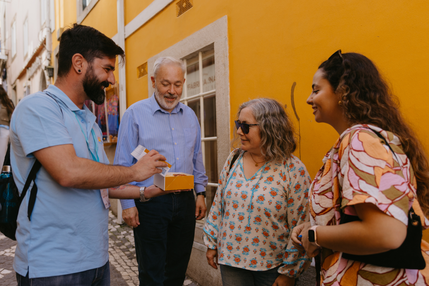 Tourists on a group tour trying the typical sweets from Sintra