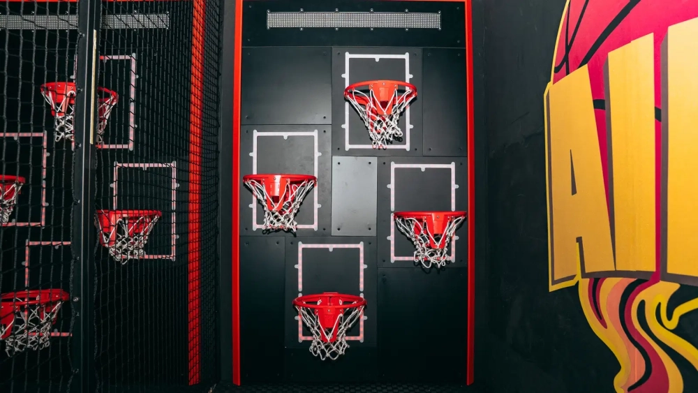 Multiple basketball hoops forming an aim challenge inside Level Arena, the immersive gaming venue near Lisbon.