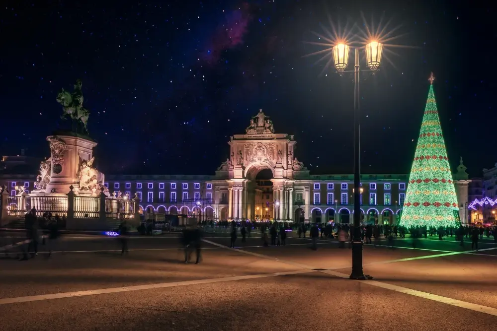 Large illuminated Christmas tree at Praça do Comércio with the Arco da Rua Augusta in the background
