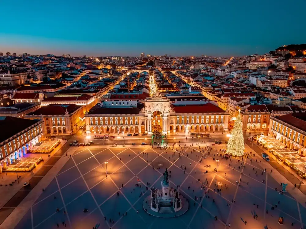 Aerial view of Praça do Comércio in Lisbon illuminated for Christmas with a large Christmas tree